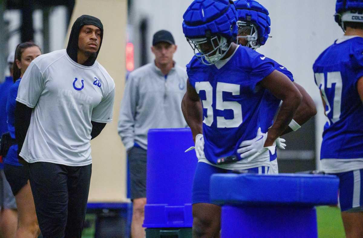 Jonathan Taylor (left) looks on as Colts players work out during training camp.