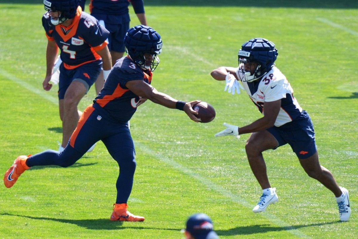 Denver Broncos quarterback Russell Wilson (3) and running back Jaleel McLaughlin (38) during drills at the Centura Health Training Center.