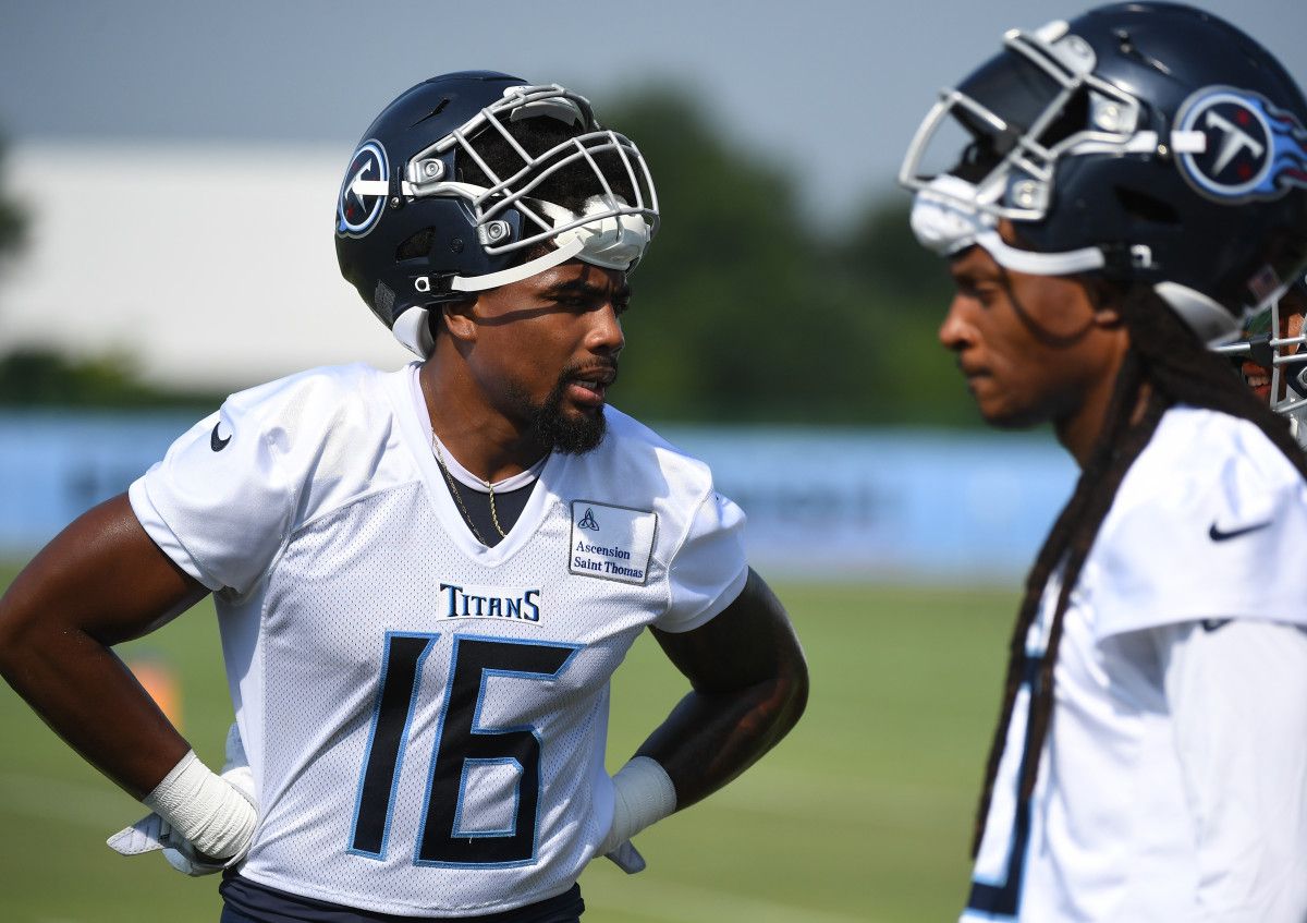 Treylon Burks and DeAndre Hopkins talk with their helmets off