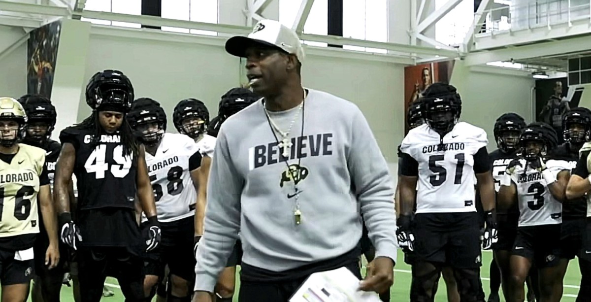 Deion Sanders talks to players during the first day on Colorado's Fall Camp