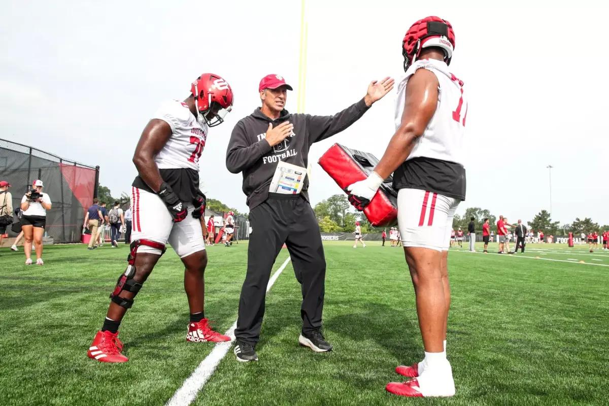 New Indiana offensive line coach Bob Bostad instructs his players during practice.