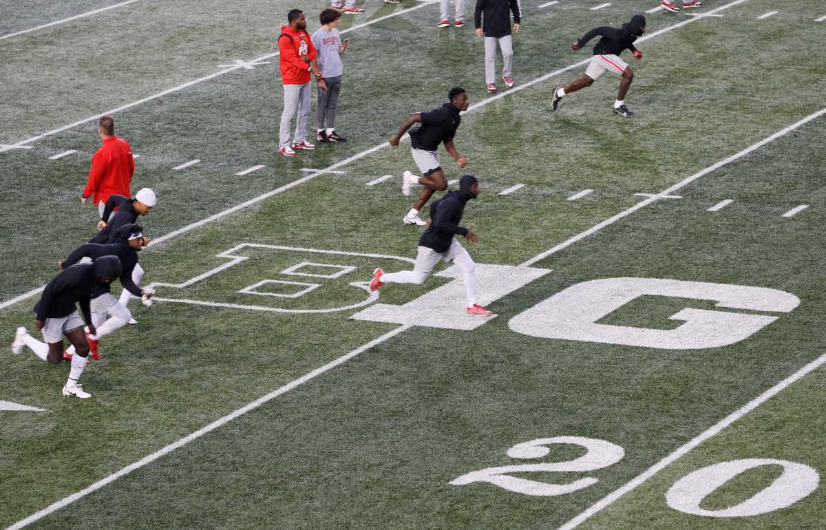 Ohio State Buckeyes players warm up on the Big Ten logo prior to the NCAA football game against the Indiana Hoosiers at Memorial Stadium in Bloomington, Ind. on Sunday, Oct. 24, 2021. Ohio State won 54-7. Ohio State Buckeyes At Indiana Hoosiers