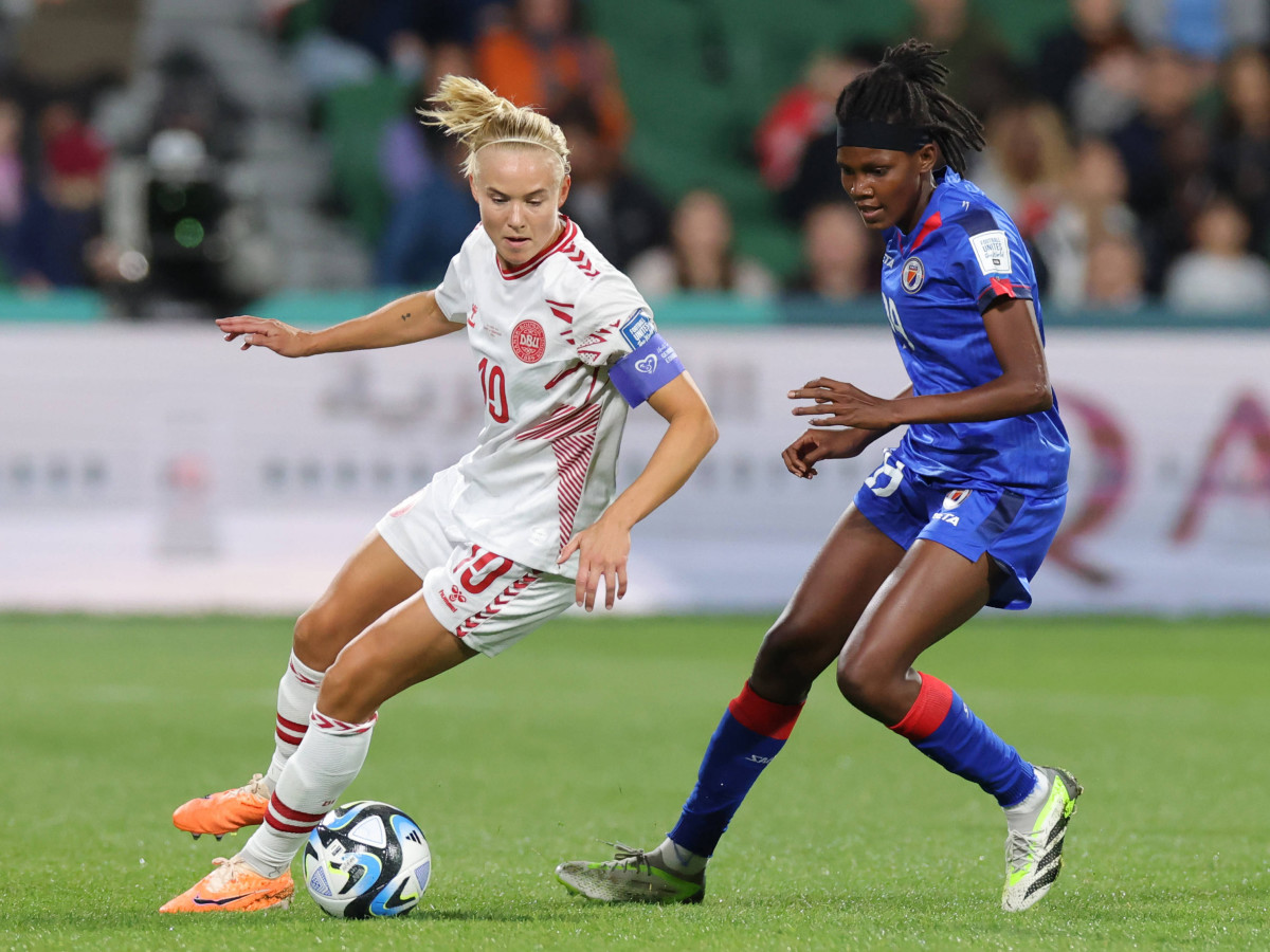 Pernille Harder of Denmark maintains possession against Dayana Pierre-Louis of Haiti during the Women's World Cup.