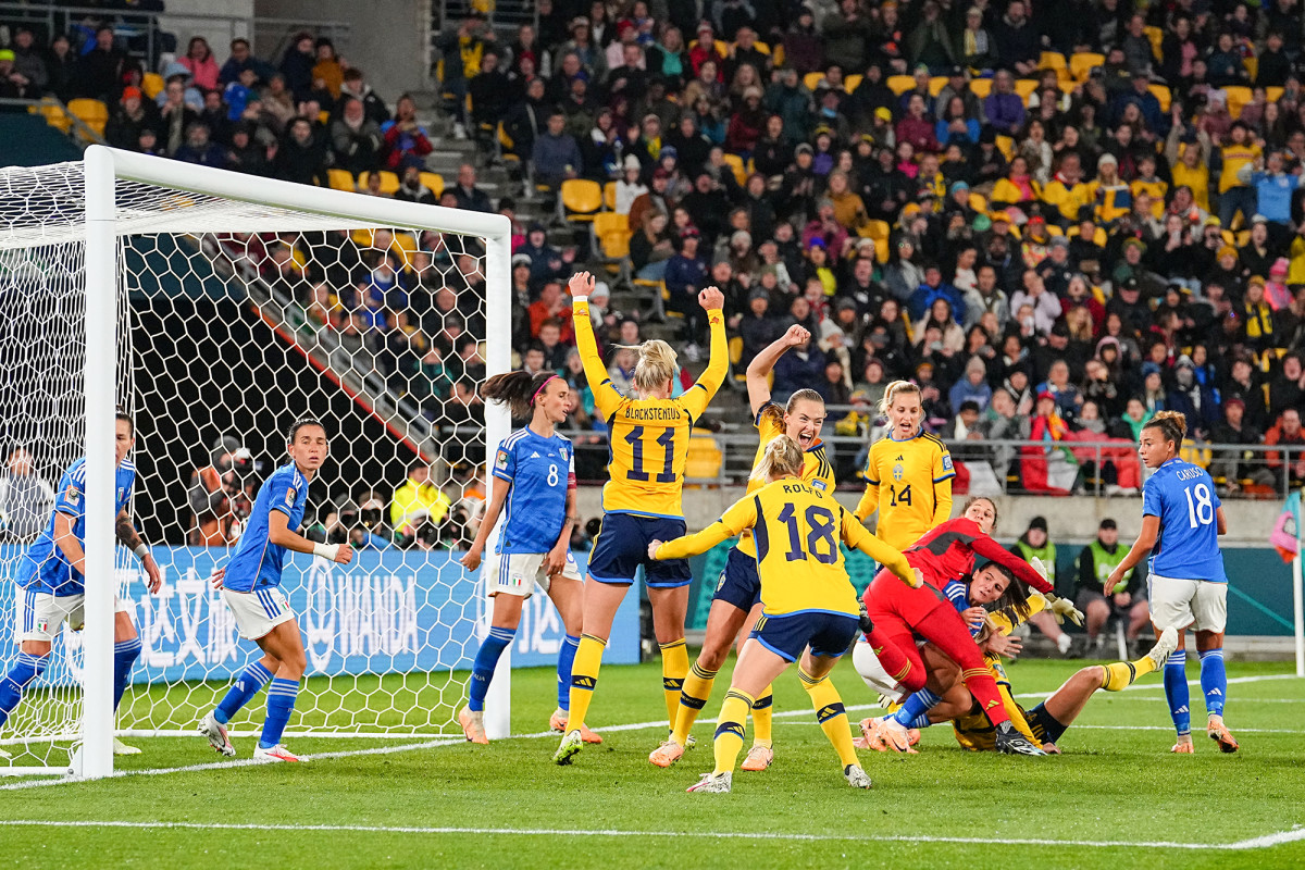 Sweden celebrates a goal against Italy near the net at the Women's World Cup.