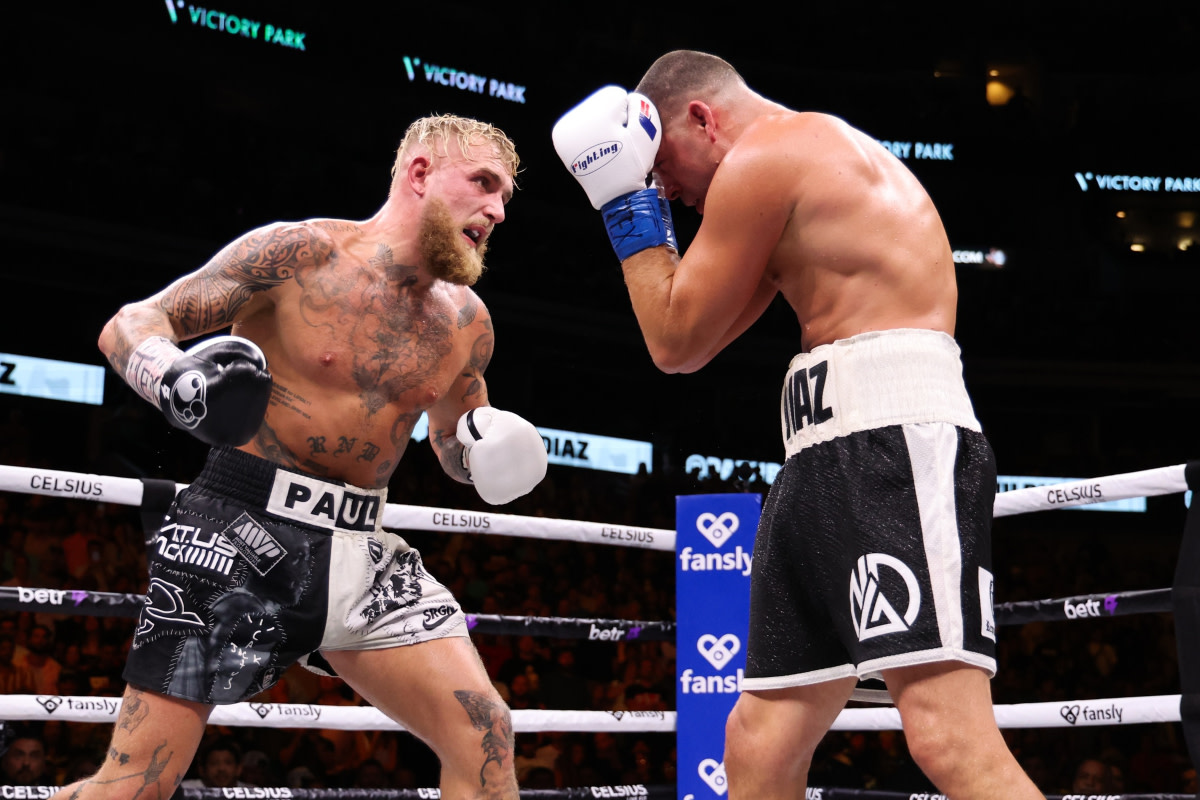 Jake Paul winds up to punch Nate Diaz, who is blocking, during their August 5 boxing match.