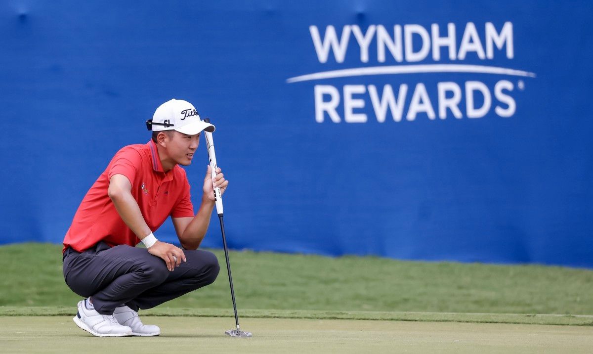 Michael Kim lines up a putt
