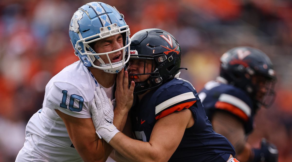 North Carolina Tar Heels quarterback Drake Maye is hit by Virginia Cavaliers linebacker James Jackson