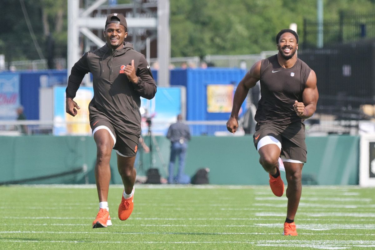 Deshaun watson (left) and Myles Garrett (right) run in warm up gear