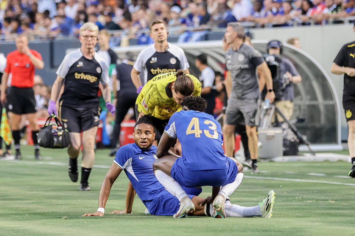 Christopher Nkunku pictured on the ground after suffering a knee injury during Chelsea's 1-1 draw against Borussia Dortmund in August 2023