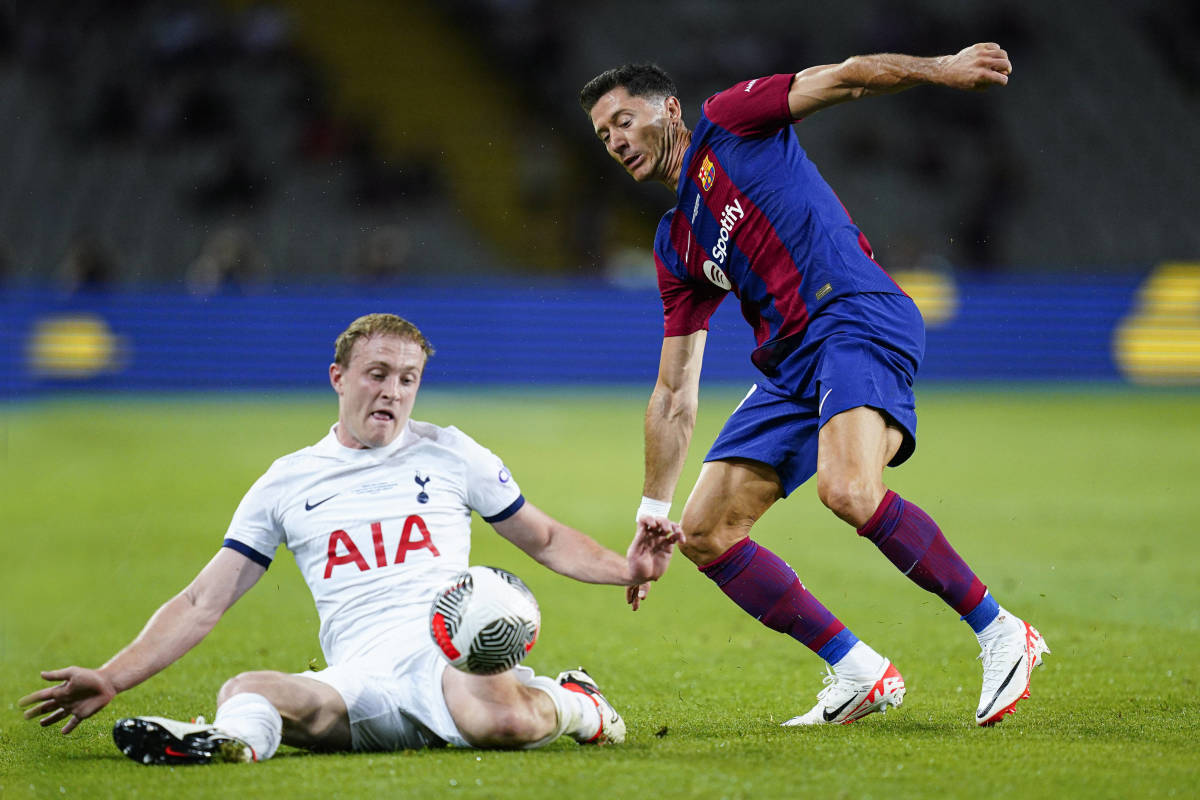 Oliver Skipp (left) and Robert Lewandowski pictured competing for the ball during Barcelona's 4-2 win over Tottenham in the 2023 Joan Gamper Trophy match