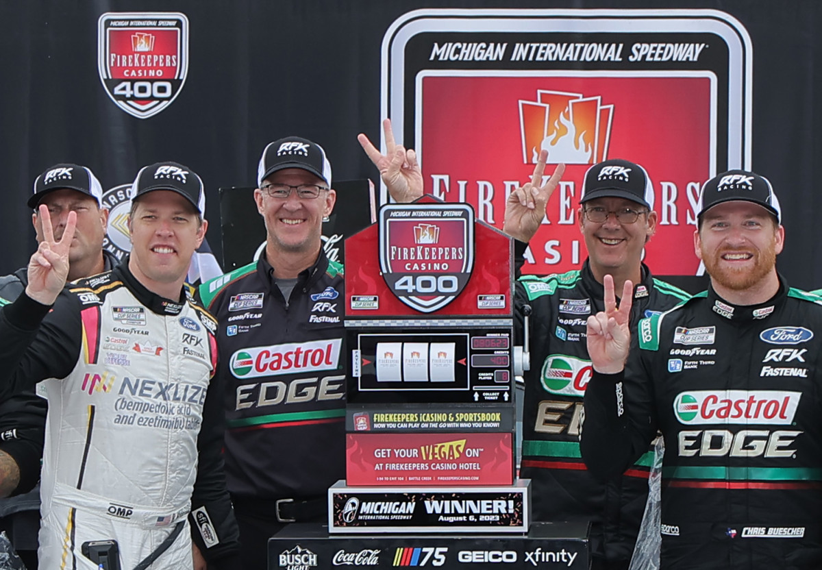 Chris Buescher celebrates with RFK Racing co-owner Brad Keselowski and crew chief Scott Graves after winning the NASCAR Cup Series FireKeepers Casino 400 at Michigan International Speedway.  (Photo by Jonathan Bachman/Getty Images)