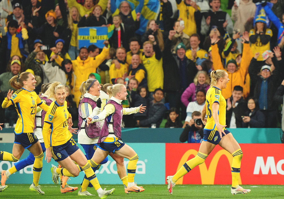 Sweden players celebrate with Swedish fans after beating the USWNT in penalty kicks during the round of 16 at the Women's World Cup.
