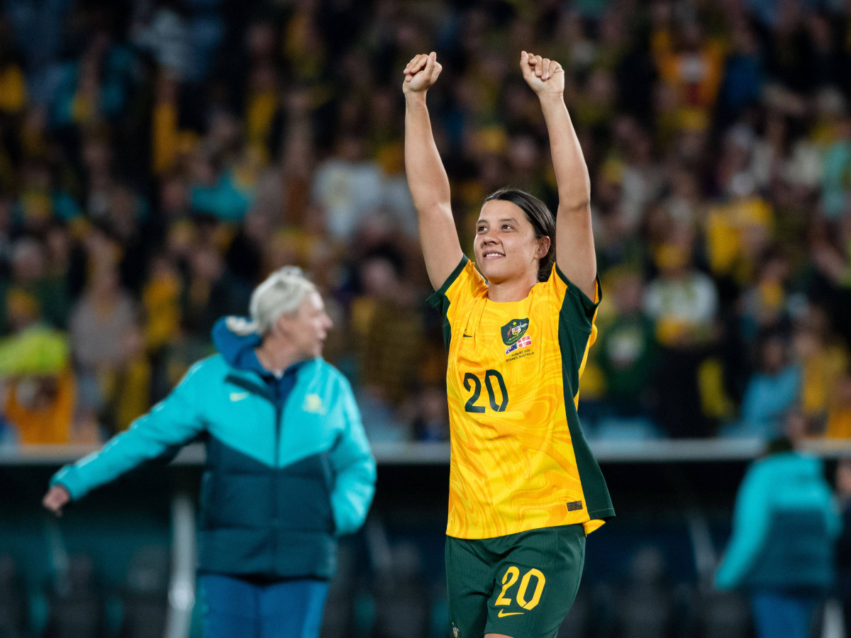 Australia's Sam Kerr raises her hands above her head to celebrate with the crowd after the Matildas defeated Denmark in the round of 16 at the Women's World Cup.