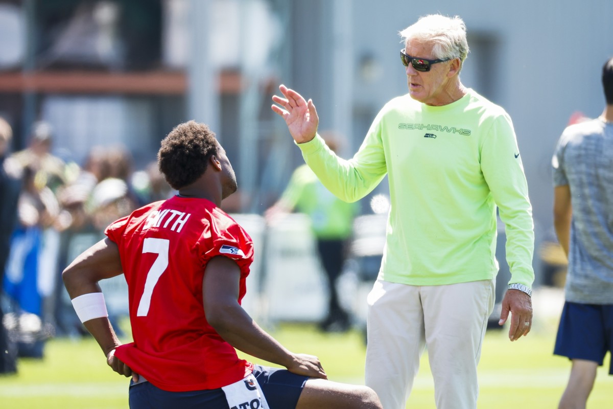 Seattle quarterback Geno Smith and coach Pete Carroll at training camp.