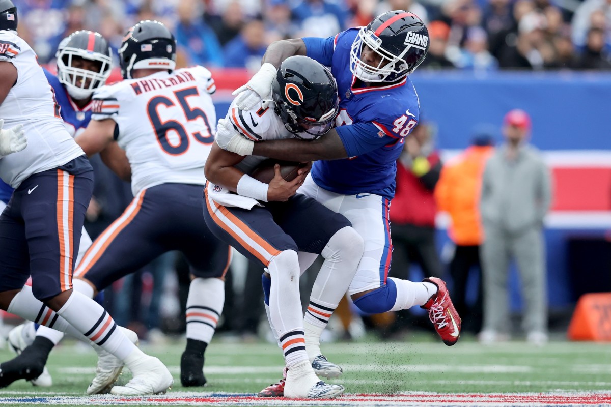 Chicago Bears quarterback Justin Fields (1) is tackled by New York Giants linebacker Tae Crowder (48). Mandatory Credit: Brad Penner-USA TODAY Sports