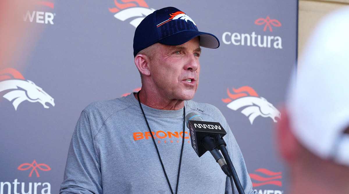Broncos coach Sean Payton at a podium during training camp