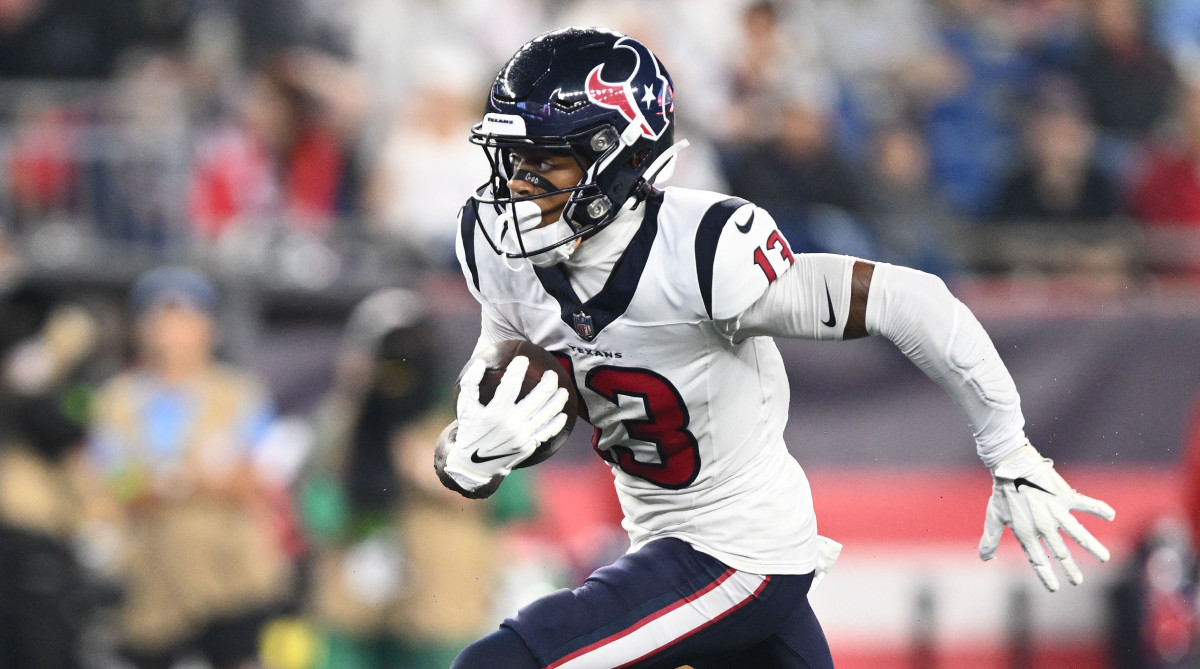 Texans wide receiver Tank Dell (13) runs with the ball against the New England Patriots.