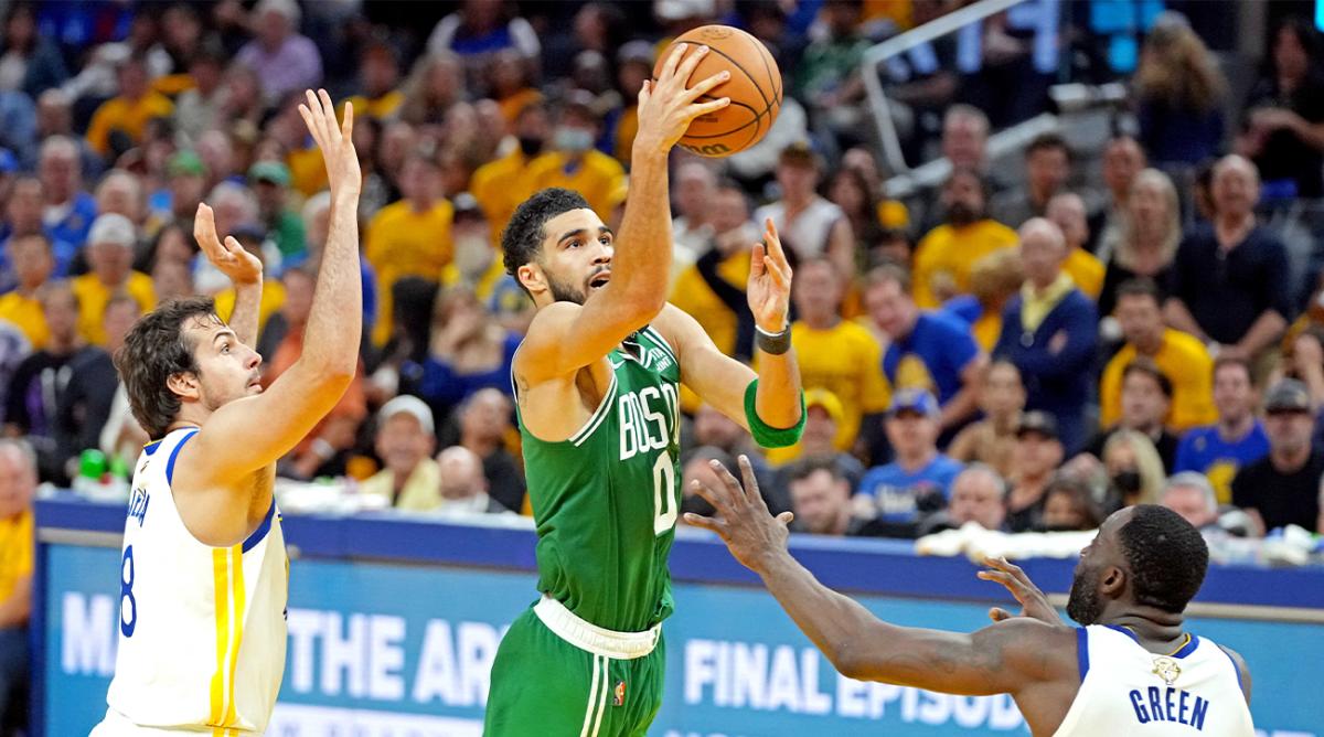 Jun 5, 2022; San Francisco, California, USA; Boston Celtics forward Jayson Tatum (0) shoots the ball against Golden State Warriors forward Draymond Green (23) during the fourth quarter during game two of the 2022 NBA Finals at Chase Center.