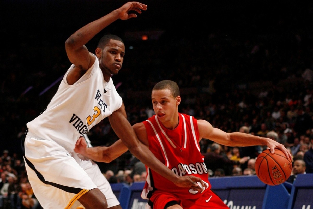 Dec 9, 2008; New York, NY, USA; Davidson Wildcats guard Stephen Curry (30) drives to the basket against West Virginia Mountaineers forward Devin Ebanks (3) during second half action at the Jimmy V Classic at Madison Square Garden. Davidson Wildcats won 68-65.