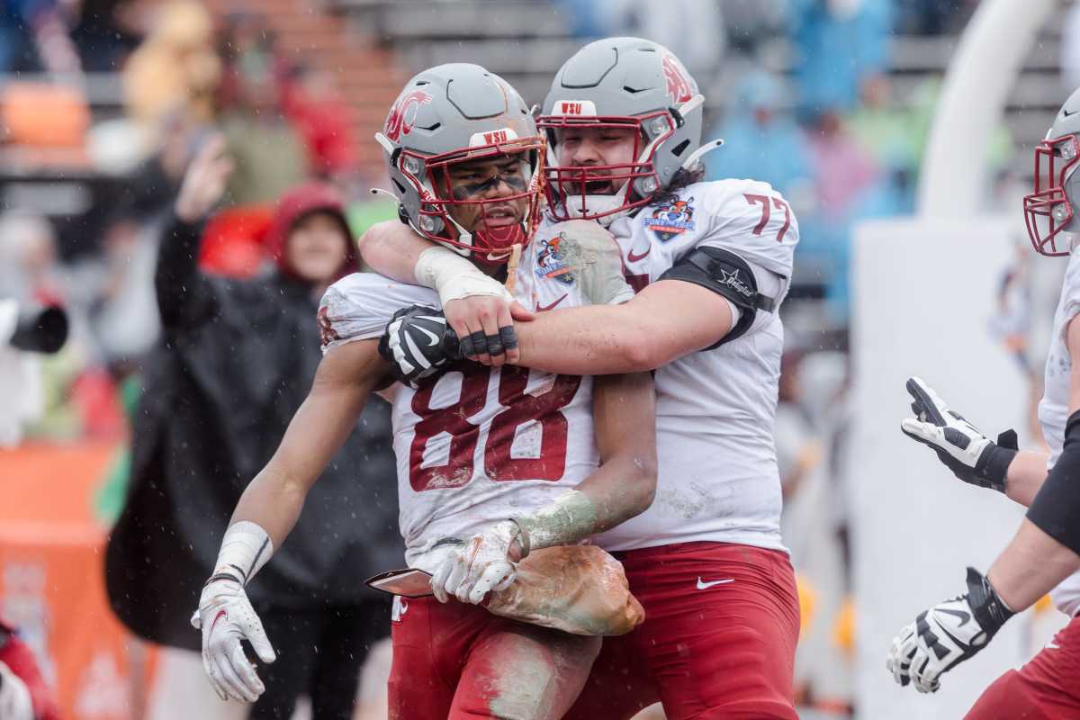 Washington State's Konner Gomes (77) celebrates with De'Zhaun Stribling (88) as he makes a touchdown in the third quarter at the 88th Tony the Tiger Sun Bowl against Central Michigan at Sun Bowl Stadium in El Paso, Texas, on Friday, Dec. 31, 2021.
