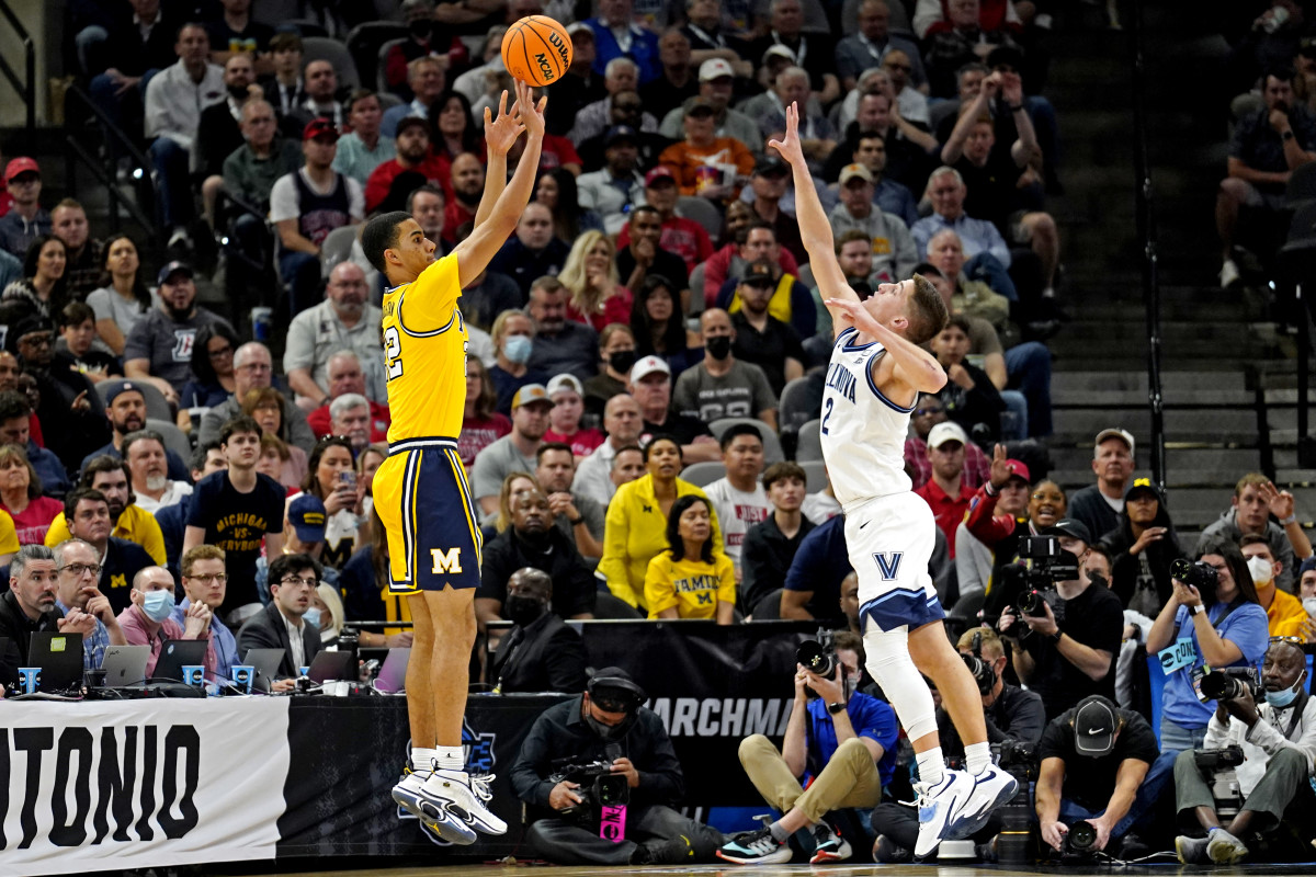 Michigan Wolverines forward Caleb Houstan (22) shoots the ball against Villanova Wildcats guard Collin Gillespie (2) in the semifinals of the South regional of the men's college basketball NCAA Tournament at AT&T Center.