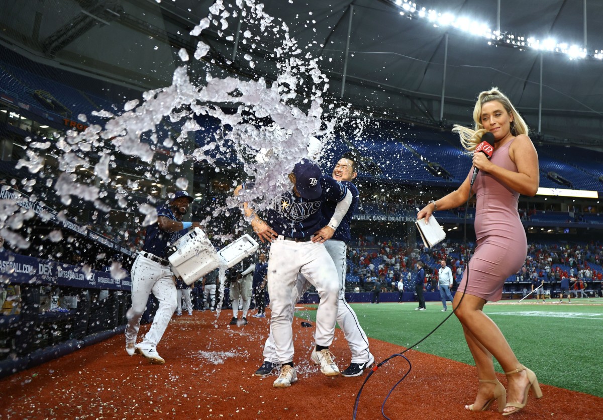 Tampa Bay Rays shortstop Taylor Walls (6) gets a Gatorade bath by Tampa Bay Rays first baseman Ji-Man Choi (26) as they beat the St. Louis Cardinals with Walls' walk-off home run during the 10th inning. Bally Sports Sun reporter Tricia Whitaker avoids the shower. (Kim Klement-USA TODAY Sports)