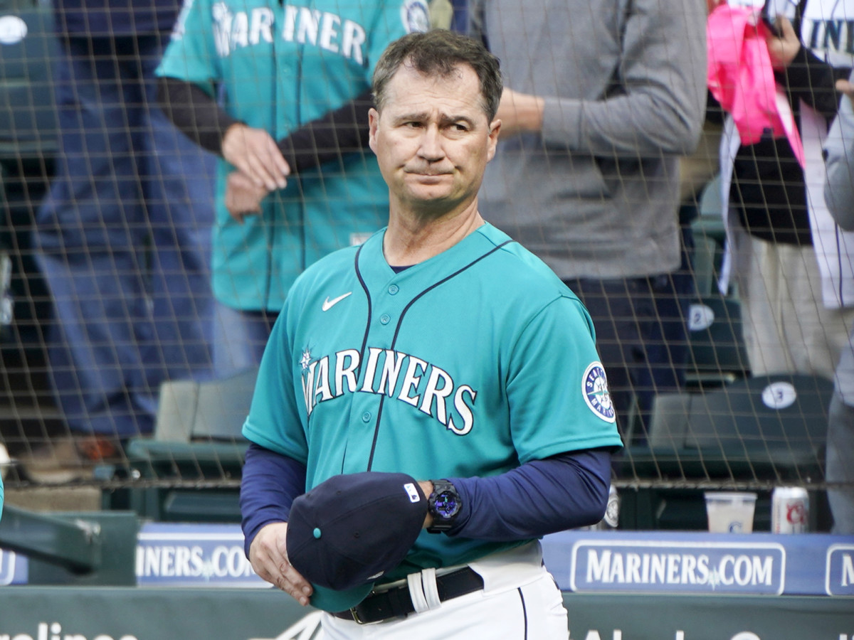 Seattle Mariners manager Scott Servais holds his cap as he stands near the dugout before a baseball game against the Houston Astros, Friday, May 27, 2022, in Seattle.