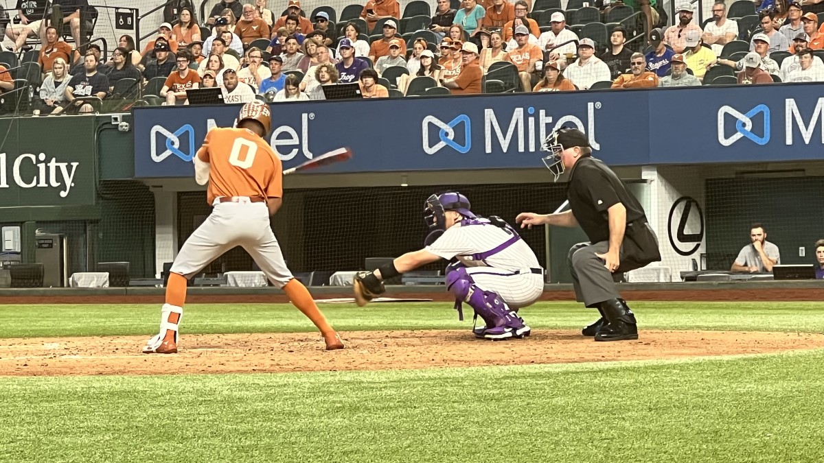 Trey Faltine of the University of Texas bats during the game versus Texas in the 2022 Big 12 Tournament. Umpire Casey Moser is behind the plate.