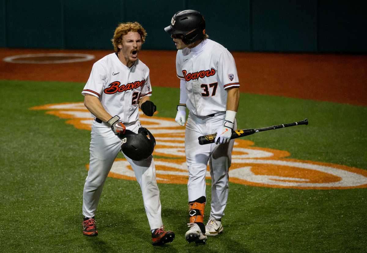 Oregon State left fielder Wade Meckler, left, celebrates after crossing home plate to score for the Beavers Friday, June 3, 2022, at the 2022 NCAA Corvallis Regional at Goss Stadium in Corvallis, Oregon.
