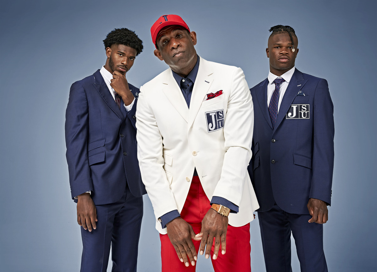 Jackson State coach Deion Sanders poses with players Shadeur Sanders and Travis Hunter