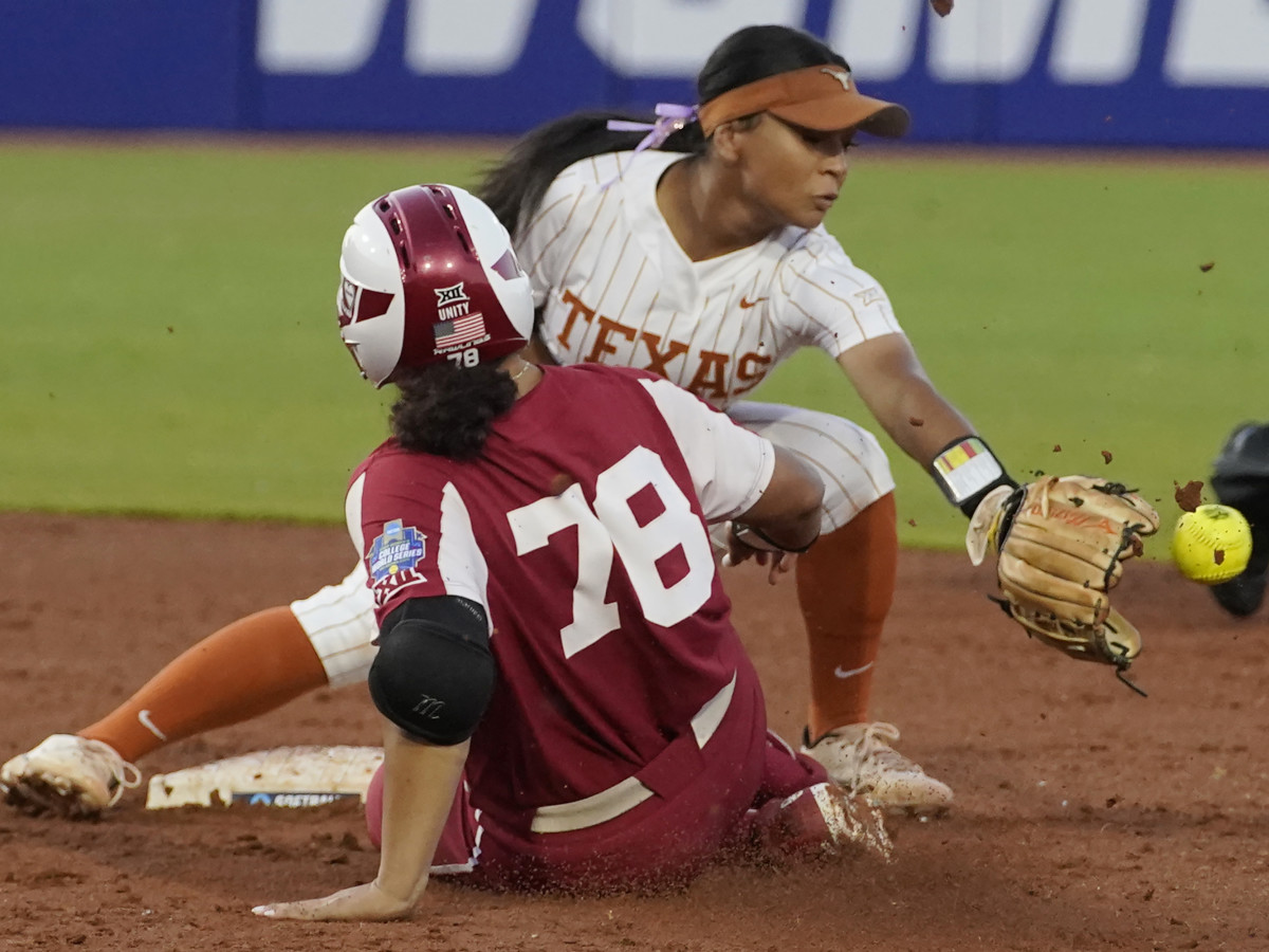 Oklahoma’s Jocelyn Alo is safe at second base with a double as Texas’ Alyssa Washington reaches for the throw.