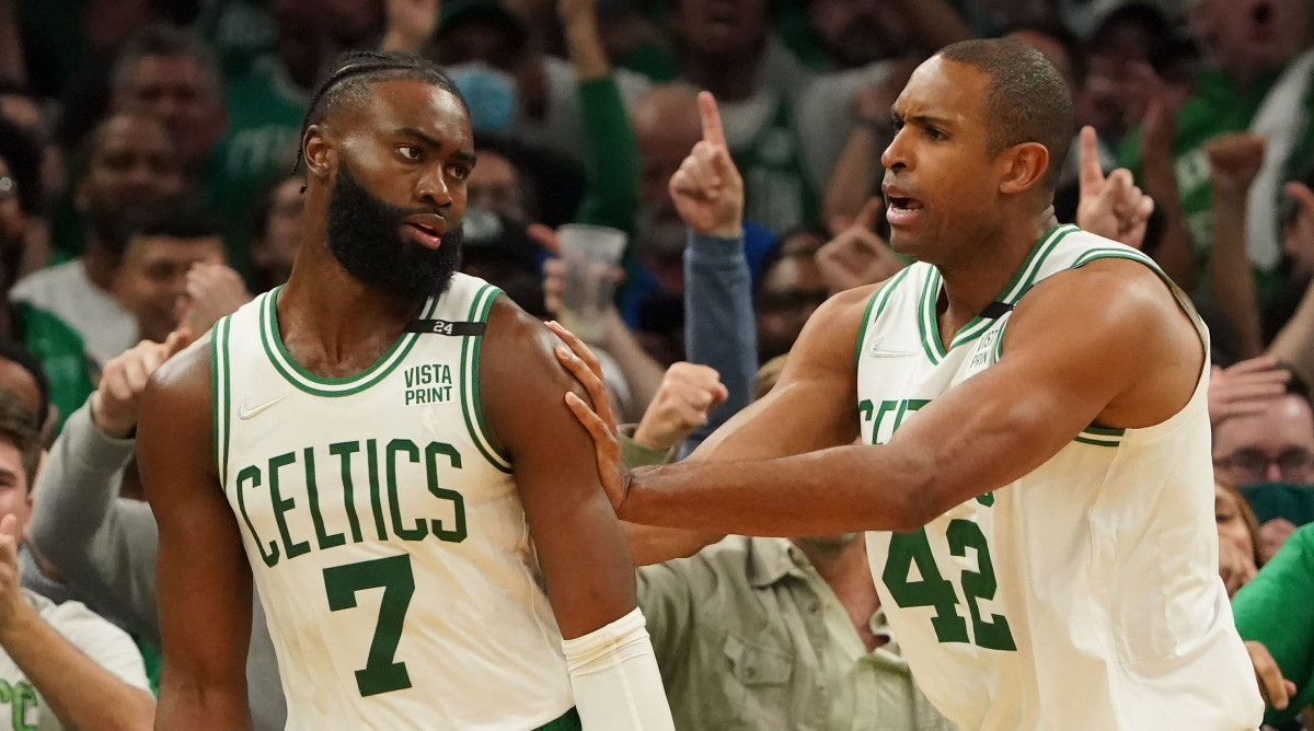 Boston Celtics center Al Horford (right) reacts after guard Jaylen Brown (left) blocks a shot by the Golden State Warriors.