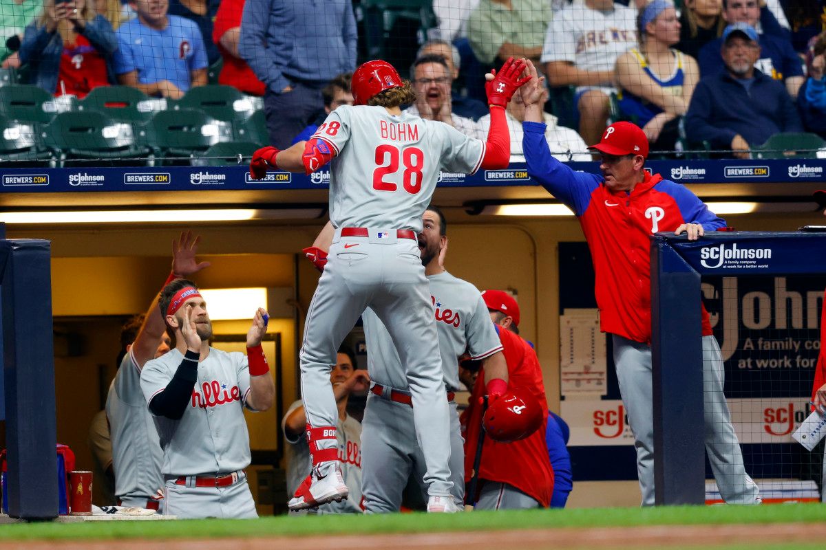 Alec Bohm high fives teammates after a home run against the Milwaukee Brewers