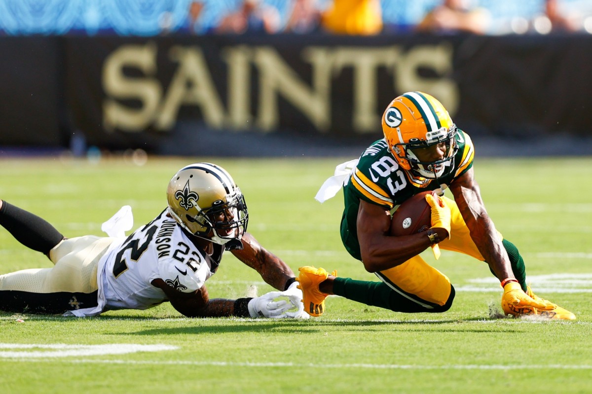 Green Bay receiver Marquez Valdes-Scantling (83) is tackled by Saints safety Chauncey Gardner-Johnson (22). Mandatory Credit: Nathan Ray Seebeck-USA TODAY Sports