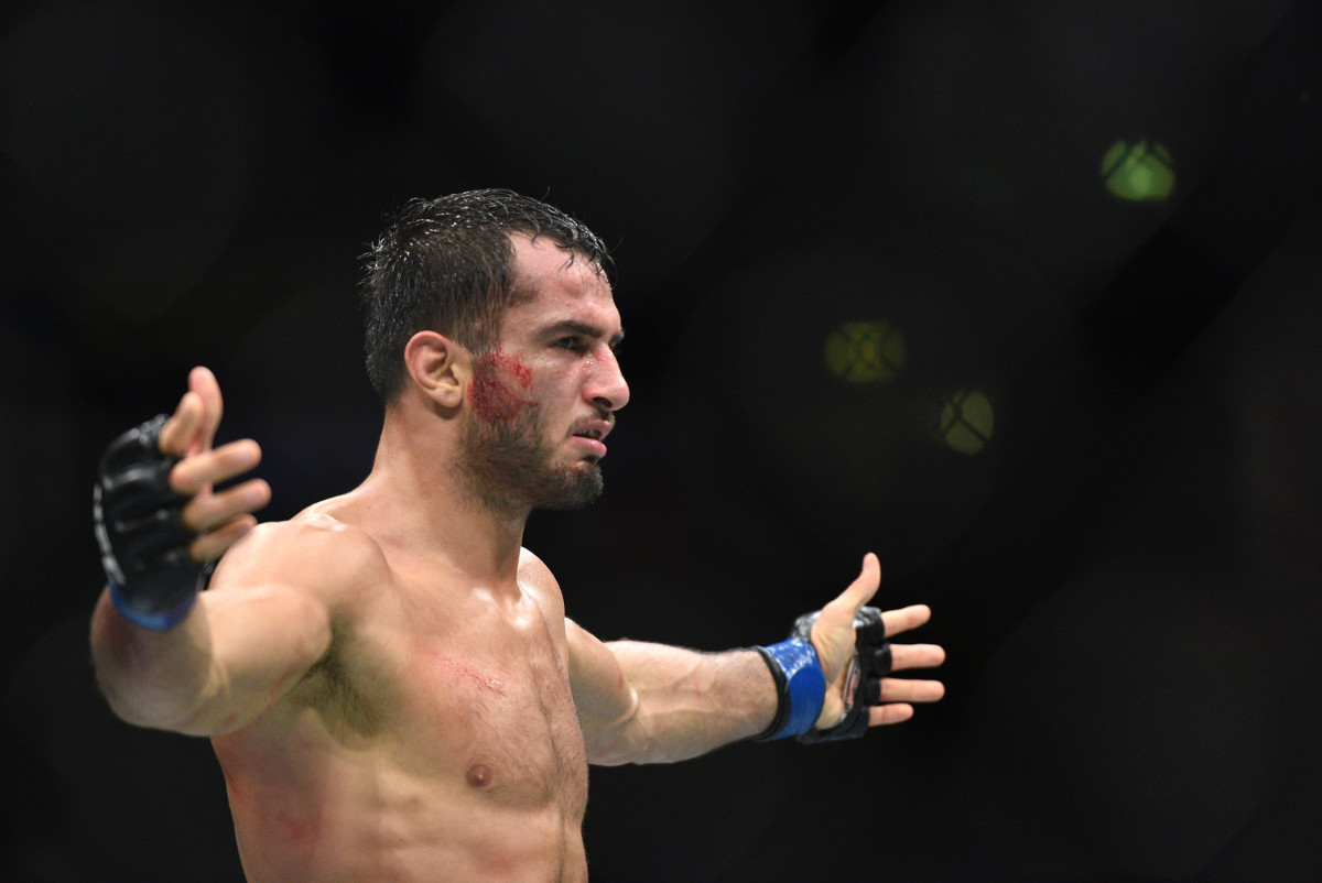 Gegard Mousasi (blue gloves) celebrates his victory over Vitor Belfort during UFC 204 at Manchester Arena.