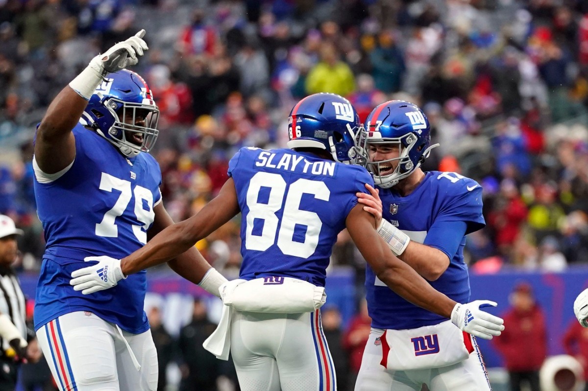 (from left) New York Giants tackle Korey Cunningham (79), wide receiver Darius Slayton (86) and quarterback Jake Fromm (17) celebrate Slayton's touchdown catch in the second half. The Giants lose to Washington, 22-7, at MetLife Stadium on Sunday, Jan. 9, 2022.