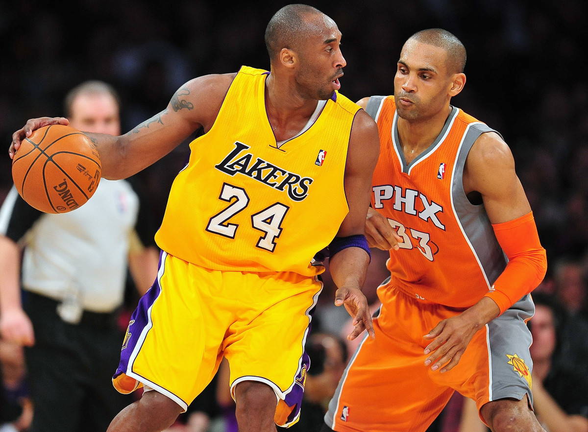 Los Angeles Lakers shooting guard Kobe Bryant (24) controls the ball against the defense of Phoenix Suns small forward Grant Hill (33) during the first half at Staples Center.