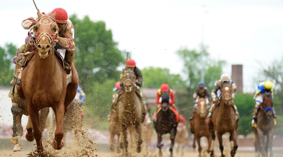 Rich Strike, left, with jockey Sonny Leon aboard, wins the Kentucky Derby.