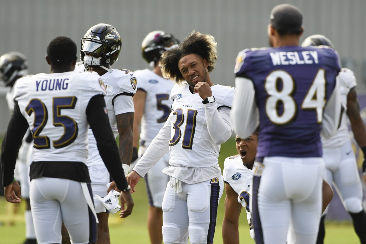 Aug 17, 2020; Owings Mills, Maryland, USA; Baltimore Ravens cornerback Khalil Dorsey (31) speaks with cornerback Tavon Young (25) and wide receiver Antoine Wesley (84) during morning practice at Under Armour Performance Center.