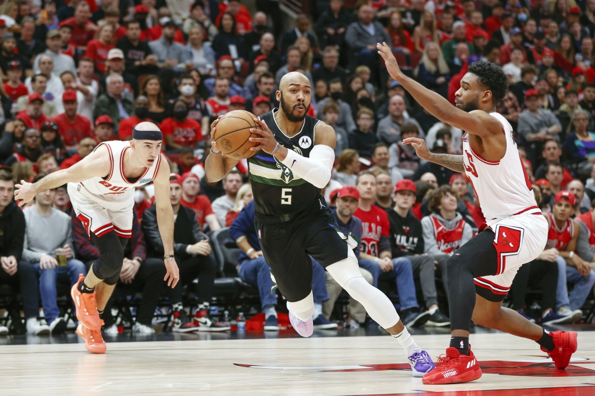 Apr 22, 2022; Chicago, Illinois, USA; Milwaukee Bucks guard Jevon Carter (5) drives to the basket against the Chicago Bulls during the first half of game three of the first round for the 2022 NBA playoffs at United Center.