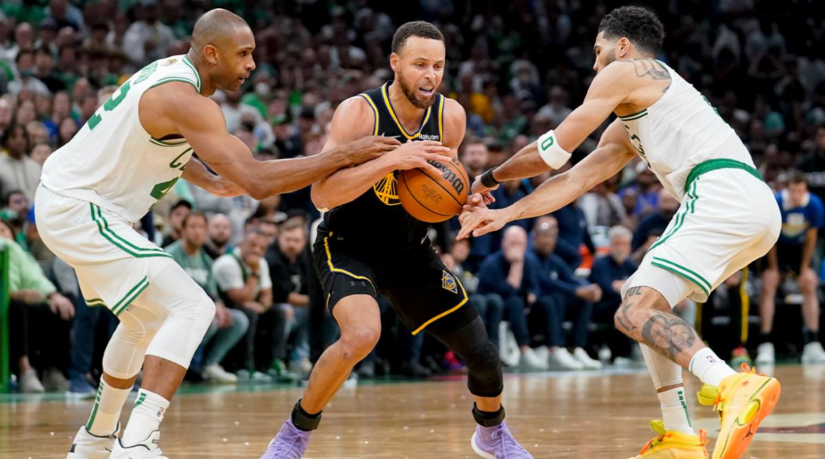 Golden State Warriors guard Stephen Curry (30) is double teamed by Boston Celtics center Al Horford (42) and forward Jayson Tatum (0) during the fourth quarter of Game 4 of basketball’s NBA Finals, Friday, June 10, 2022, in Boston.