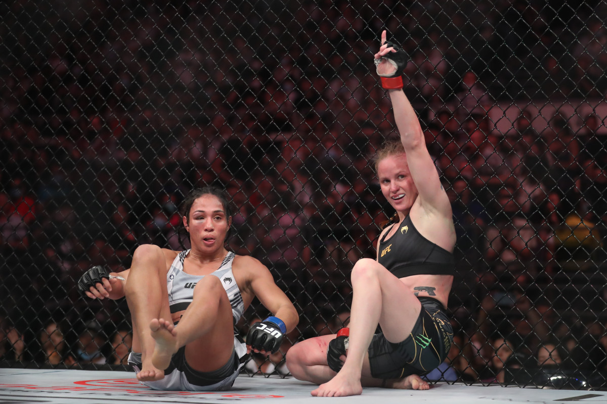 Valentina Shevchenko (red gloves) reacts after the fight against Taila Santos (blue gloves) during UFC 275 at Singapore Indoor Stadium.