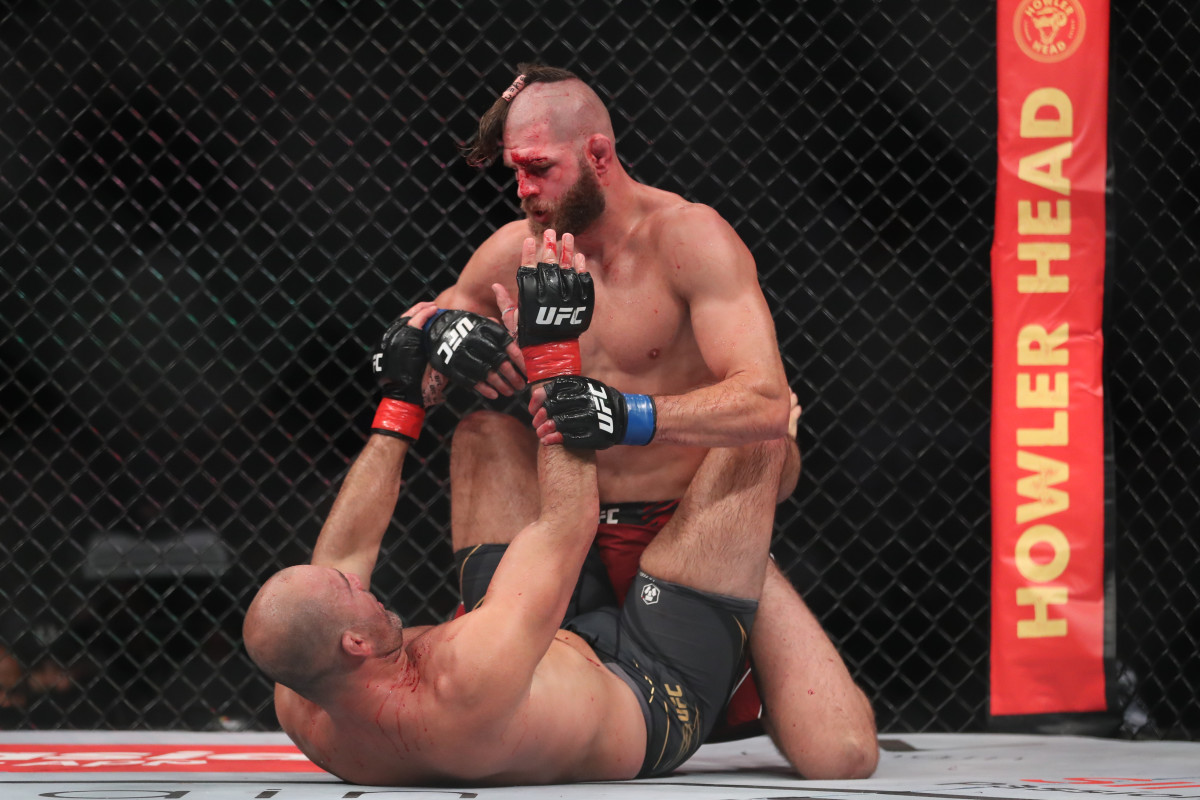 Glover Teixera (red gloves) fights Jiri Prochazka (blue gloves) during UFC 275 at Singapore Indoor Stadium.