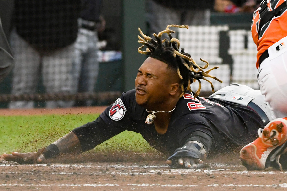 Jun 3, 2022; Baltimore, Maryland, USA;  Cleveland Guardians third baseman Jose Ramirez (11) slides past Baltimore Orioles designated hitter Adley Rutschman (35) to score during the third inning at Oriole Park at Camden Yards.