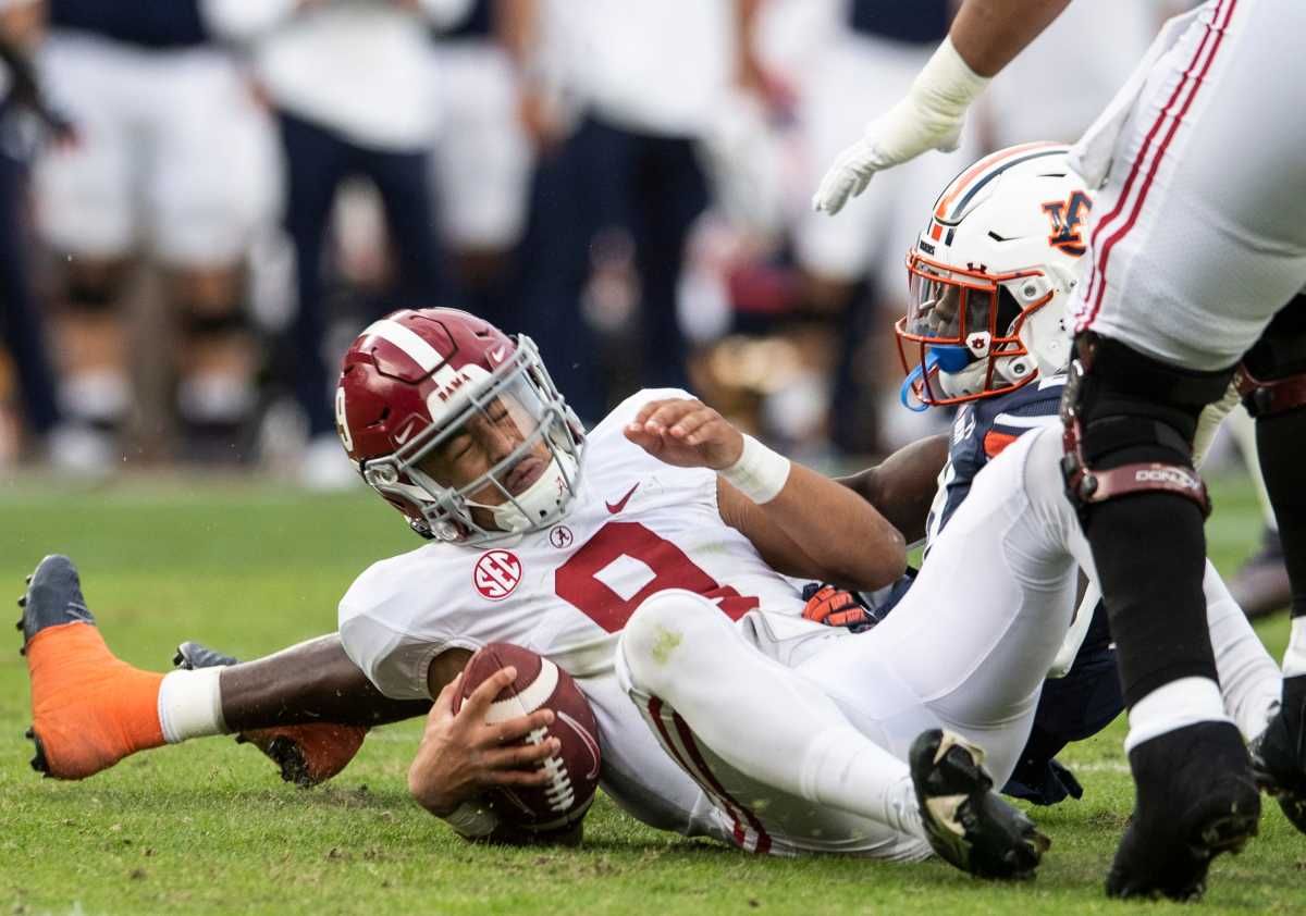 Auburn Tigers safety Smoke Monday (21) sacks Alabama Crimson Tide quarterback Bryce Young (9) during the Iron Bowl at Jordan-Hare Stadium in Auburn, Ala., on Saturday, Nov. 27, 2021.