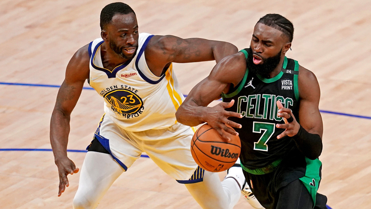 Boston Celtics guard Jaylen Brown (7) drives to the basket against Golden State Warriors forward Draymond Green.