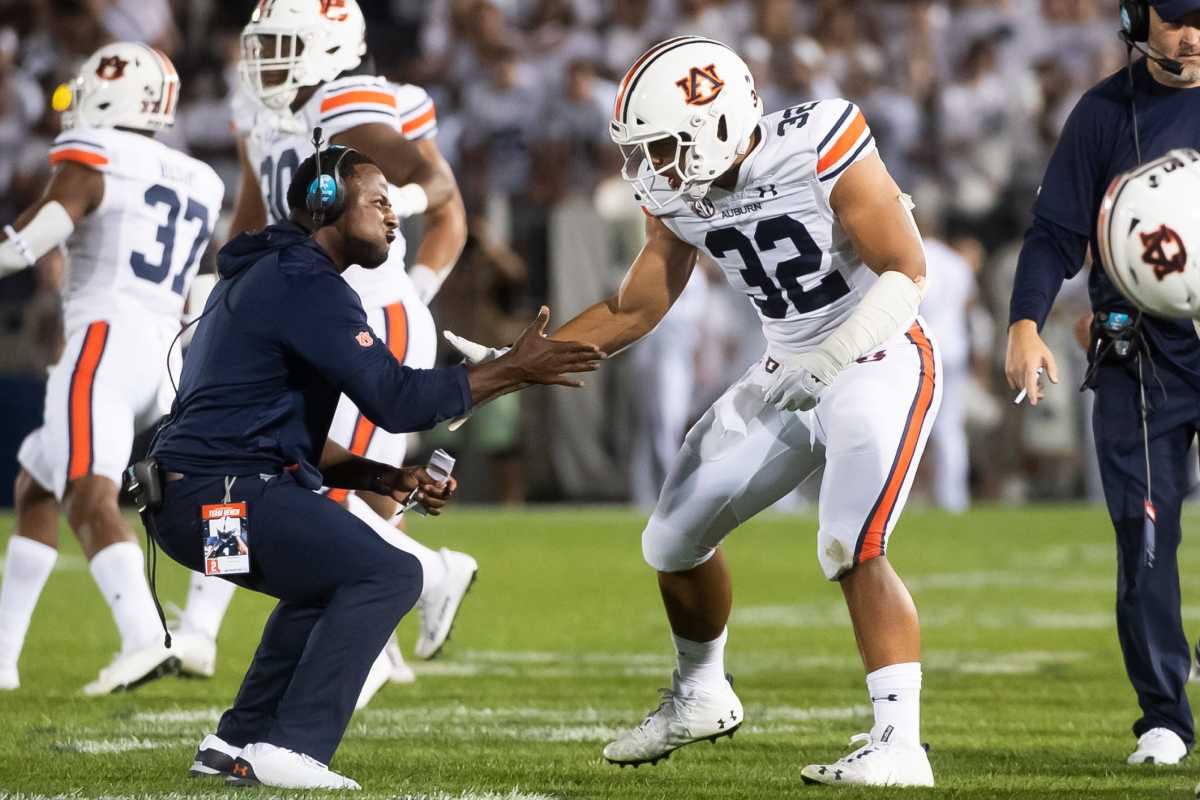 Auburn's Wesley Steiner celebrates with a coach after the Tigers made a defensive stop against Penn State on a third-down play at Beaver Stadium on Saturday, Sept. 18, 2021, in State College. Hes Dr 091821 Pennstate 36