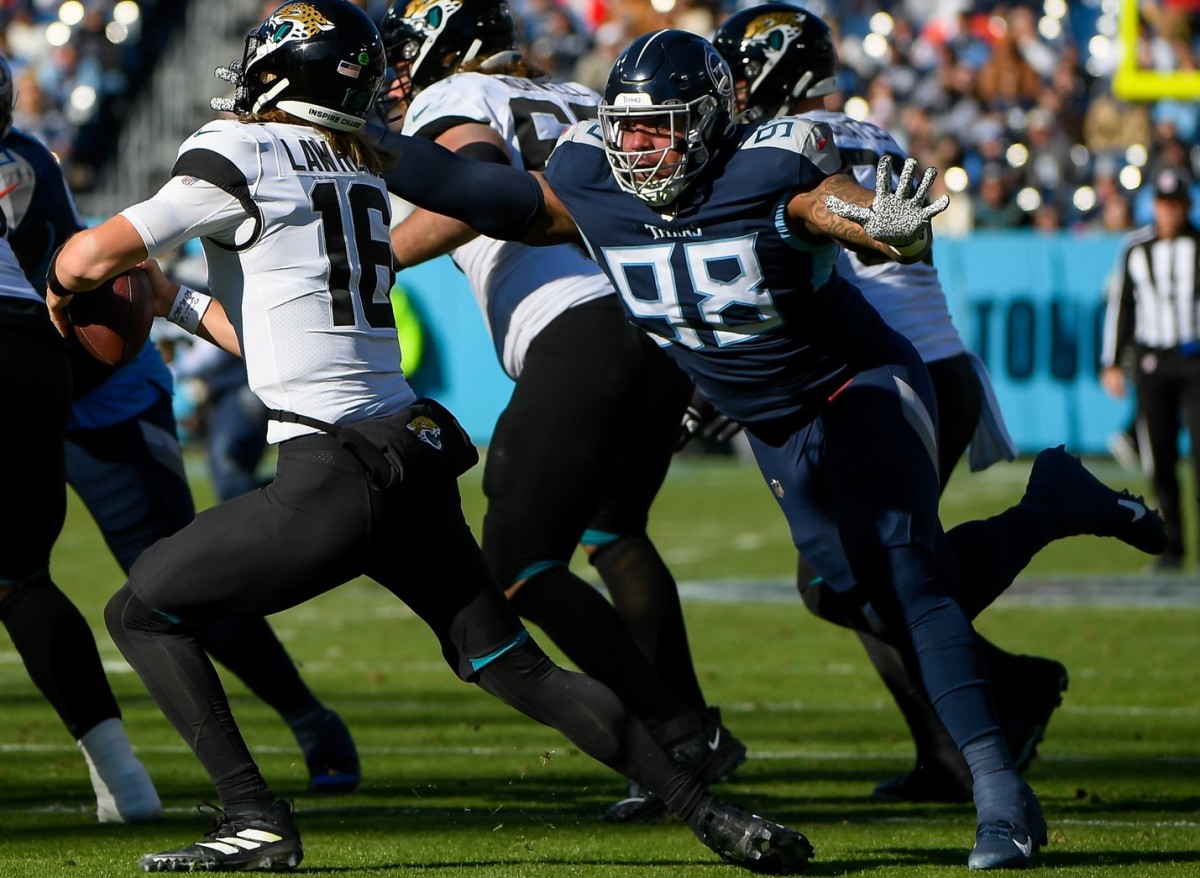 Jacksonville Jaguars quarterback Trevor Lawrence (16) and Tennessee Titans defensive tackle Jeffery Simmons (98) during the first half at Nissan Stadium.