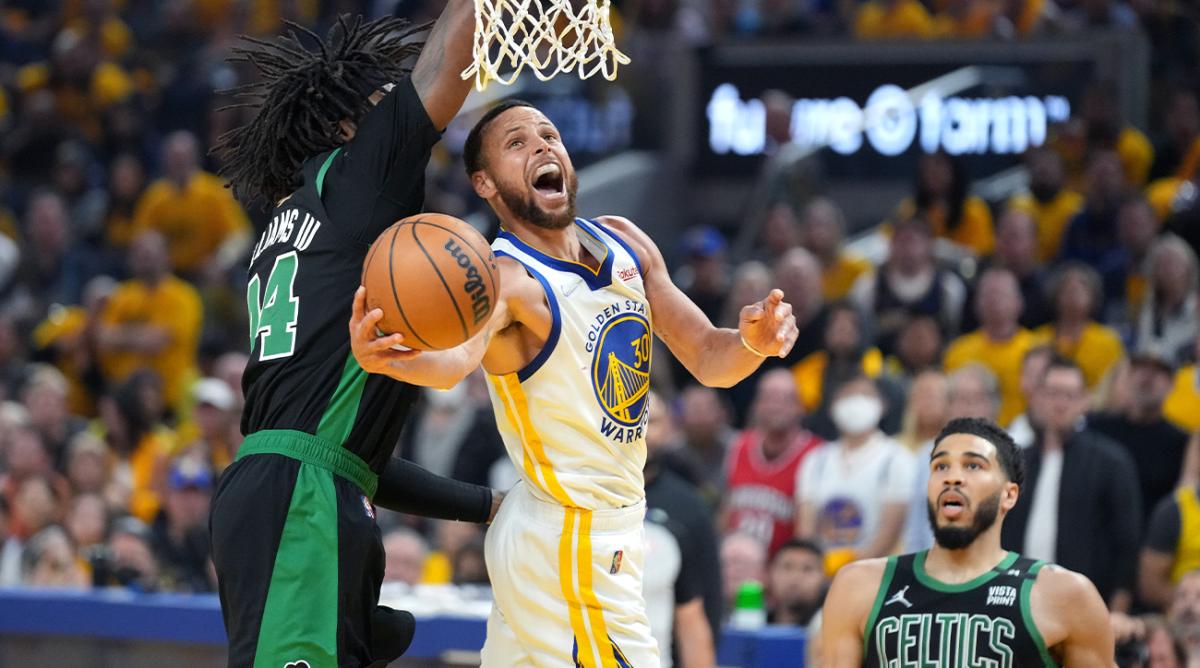 Jun 13, 2022; San Francisco, California, USA; Golden State Warriors guard Stephen Curry (30) goes to the basket while defended by Boston Celtics center Robert Williams III (44) during the first half in game five of the 2022 NBA Finals at Chase Center.