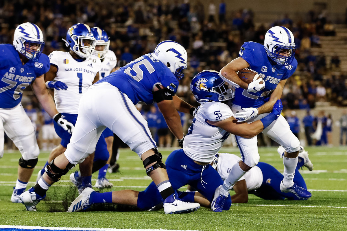 Sep 27, 2019; Colorado Springs, CO, USA; Air Force Falcons running back Kadin Remsberg (24) is tackled by San Jose State Spartans linebacker Kyle Harmon (45) as offensive lineman Colin Marquez (75) defends in the second quarter at Falcon Stadium. Mandatory Credit: Isaiah J. Downing-USA TODAY Sports
